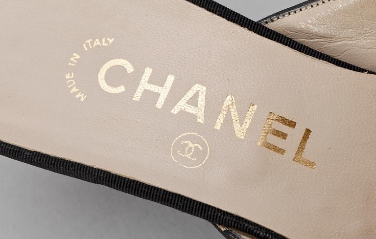 A pair of black slip-in by Chanel.