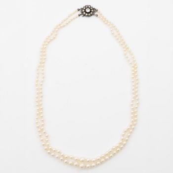 Double-row necklace with graduated cultured pearls, silver clasp set with paste stones.