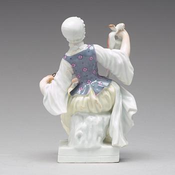 A Meissen figure of a woman preparing a rabbit, second half of 19th Century.