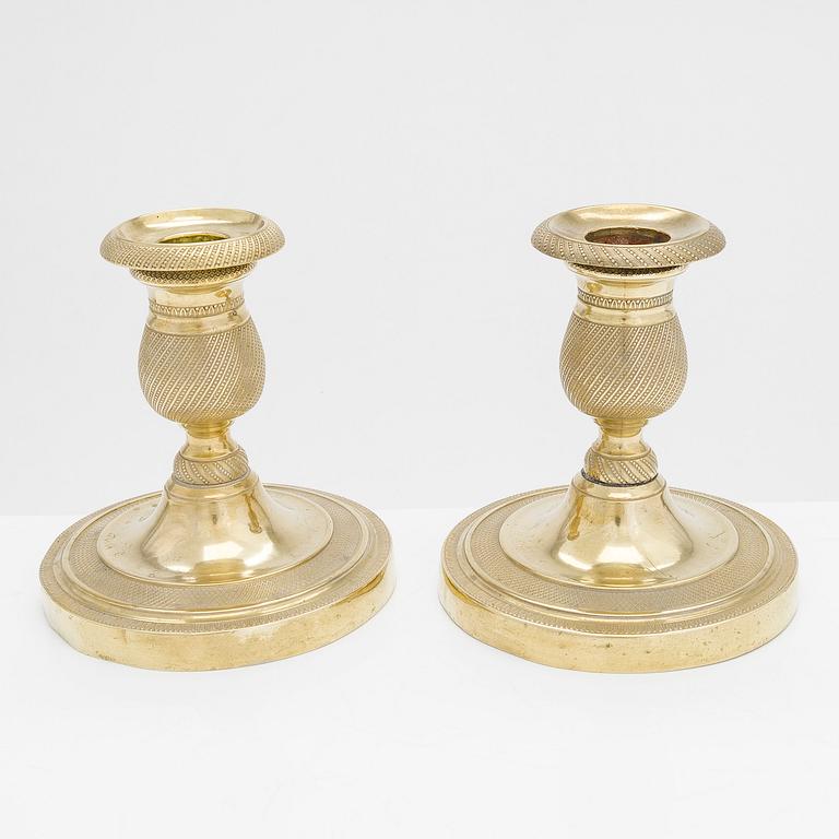 A pair of early 19th century French gilded Empire candlesticks.