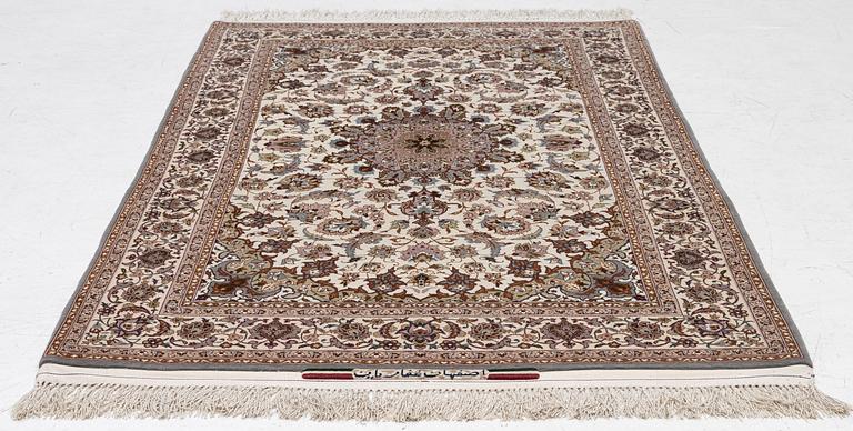 A semi-antique Isfahan rug, central Persia, signed Ghaffarian, c. 180 x 112 cm.