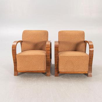 A pair of Art Deco walnut armchairs.