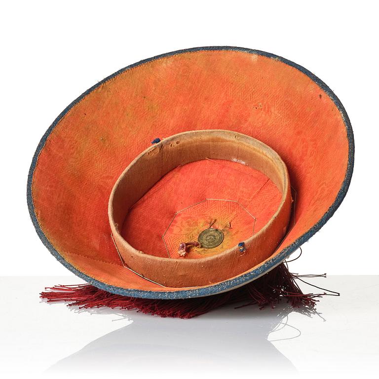 Two boxes with a mandarin's summer hat and black satin autumn hat and feather with six mandarin hat insignias.