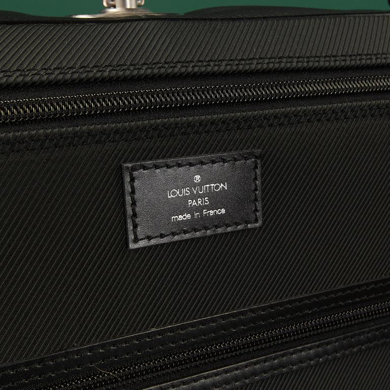 A Garment bag by Louis Vuitton.