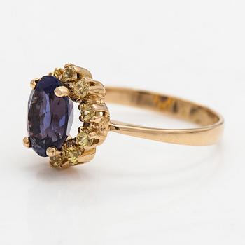 An 18K gold ring with a tanzanite and yellow sapphires.