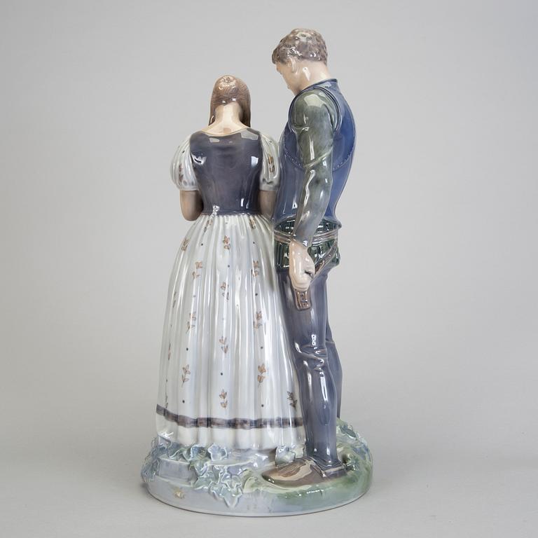 A porcelain figurine of a boy and girl model 3171 Royal Copenhagen.