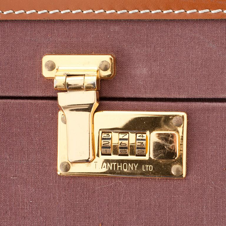 T ANTHONY Ltd, a aubergine canvas suitcase from the 1970s.