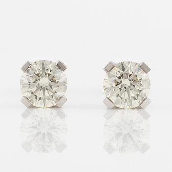 A pair of 18K gold earrings with round brilliant-cut diamonds.