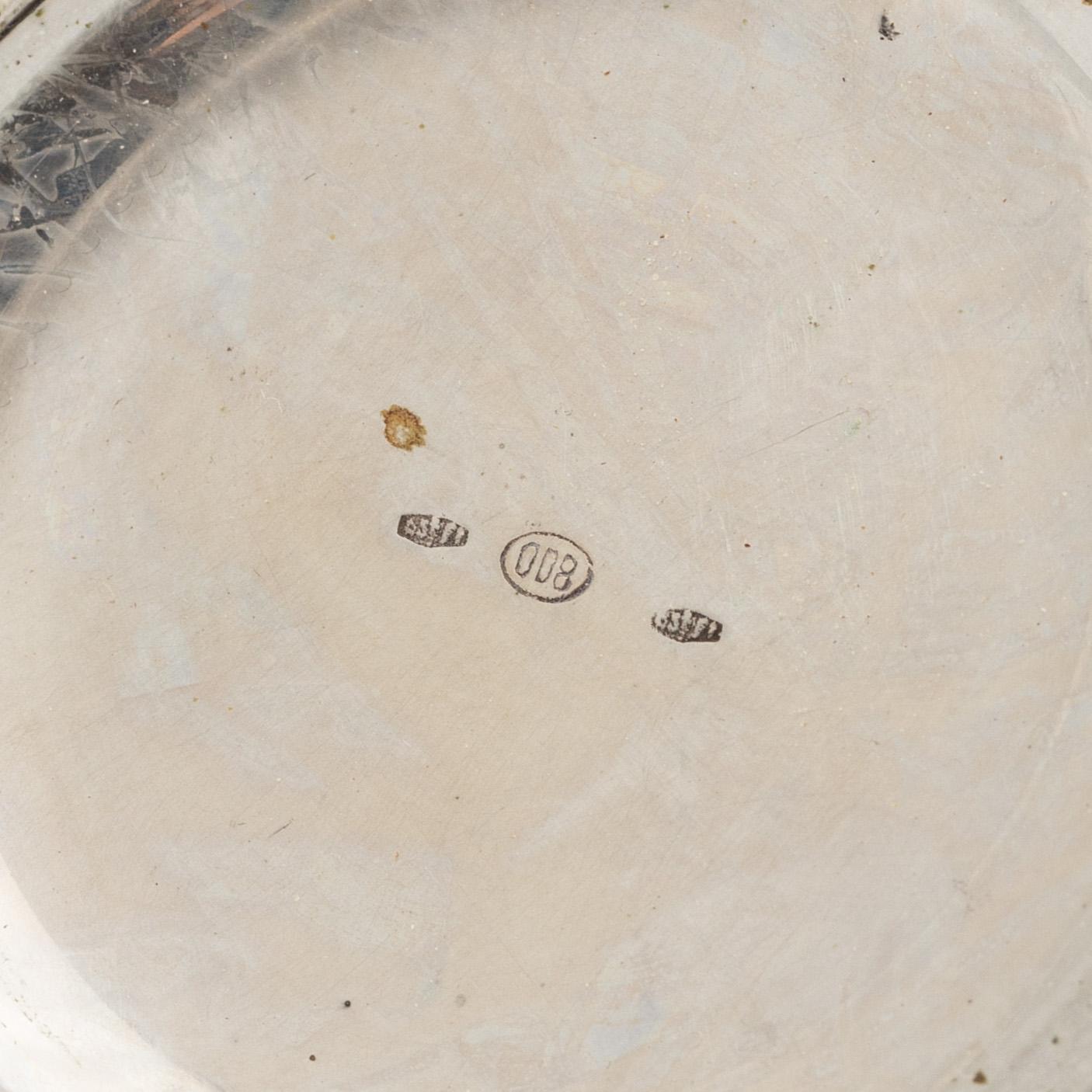 Three Silver Shakers and a Beaker.