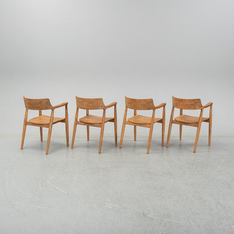 Four contemporary teak armchairs.
