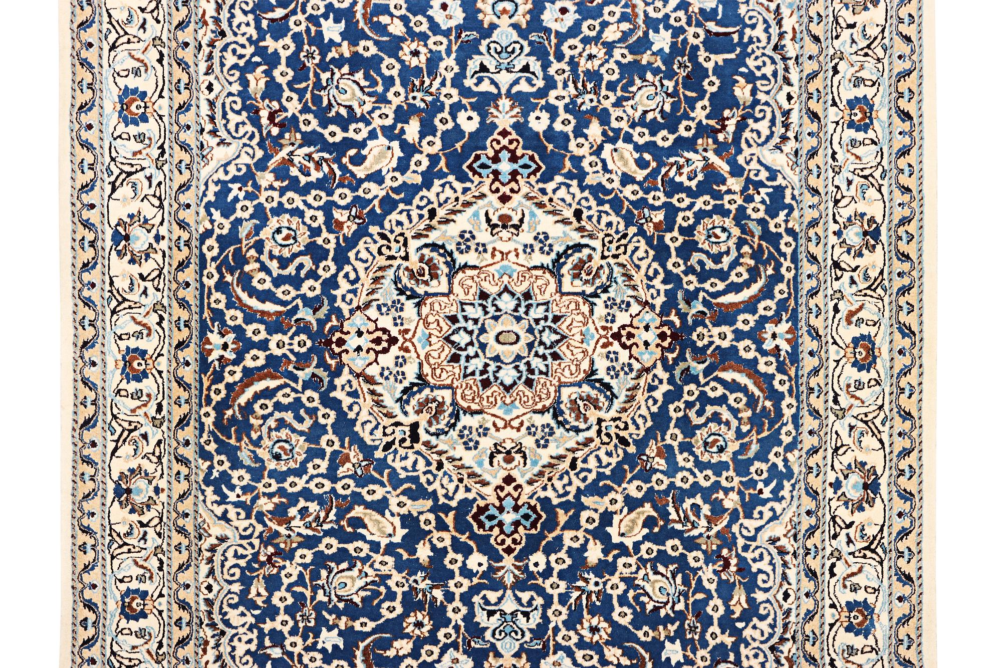 A Nain carpet, part silk, 9 laa, c. 300 x 189 cm.