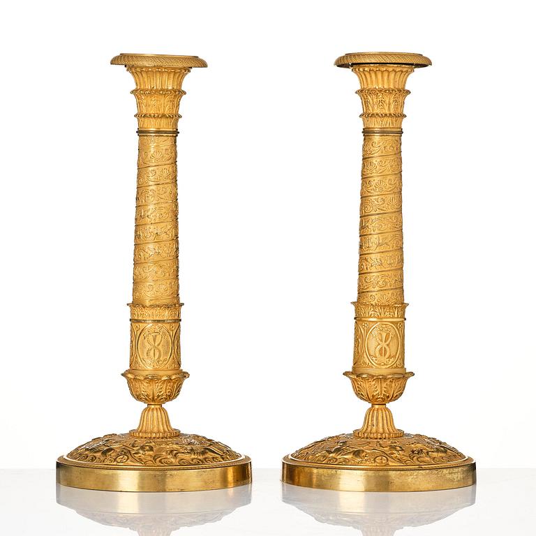 A pair of French Empire ormolu candlesticks, Paris, early 19th century.