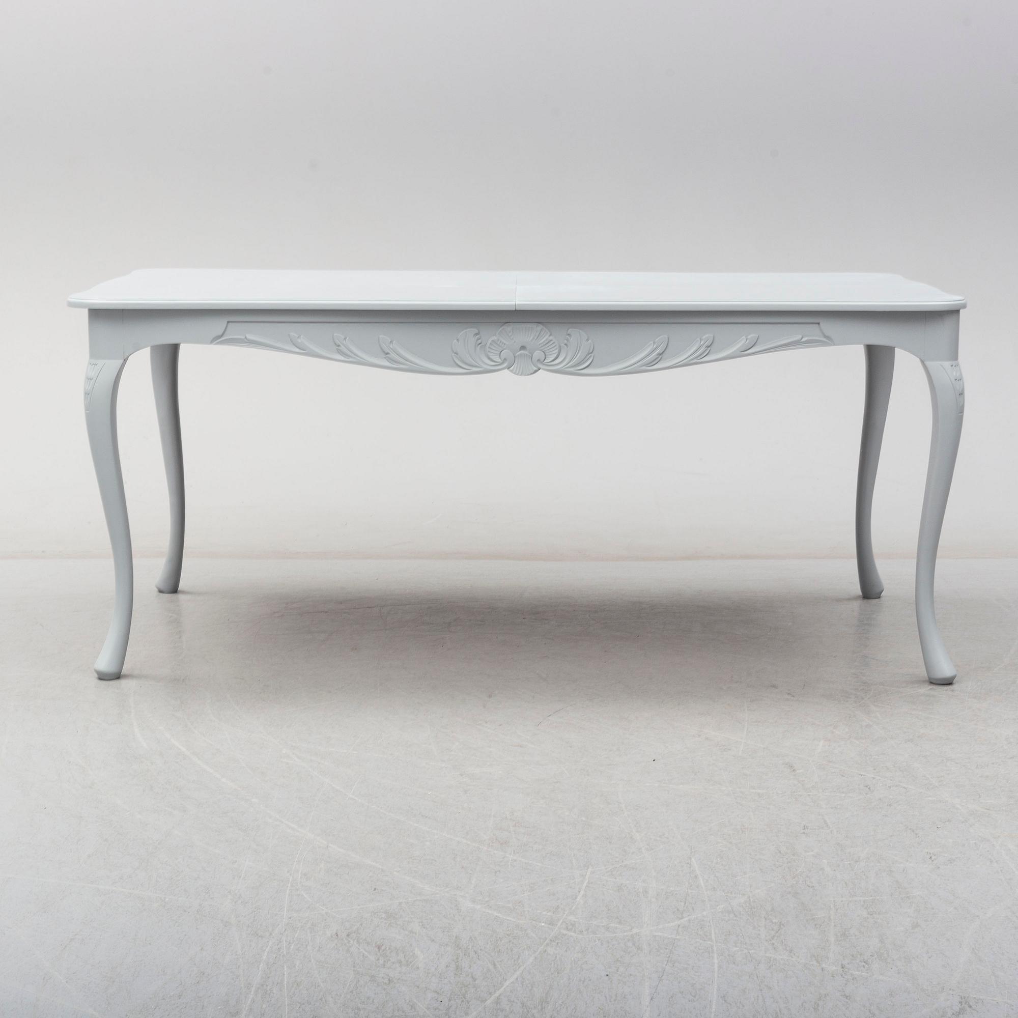 A rococo style dining table and six chairs, end of 20th century.