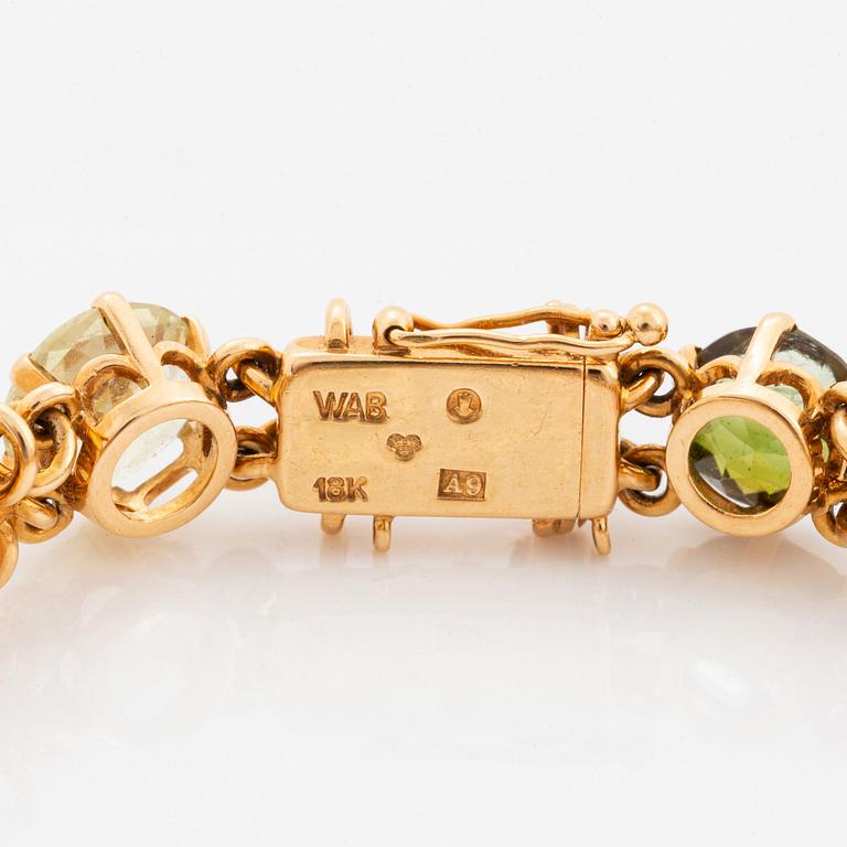 A WA Bolin bracelet in 18K gold set with coloured gemstones.