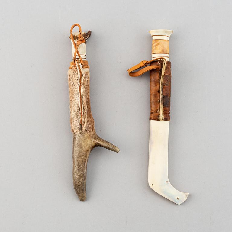 Erik Tuolja, two Sami reindeer horn, birch wood, fur and leather knives, one signed ET.