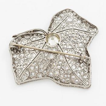 A brooch in platinum set with round brilliant-cut and eight-cut diamonds.