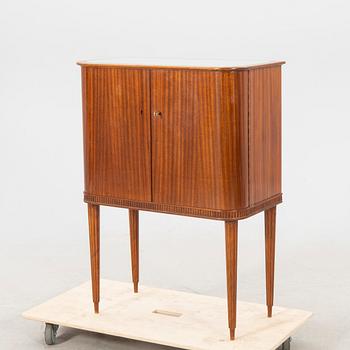 A 1950s mahogany bar cabinet.