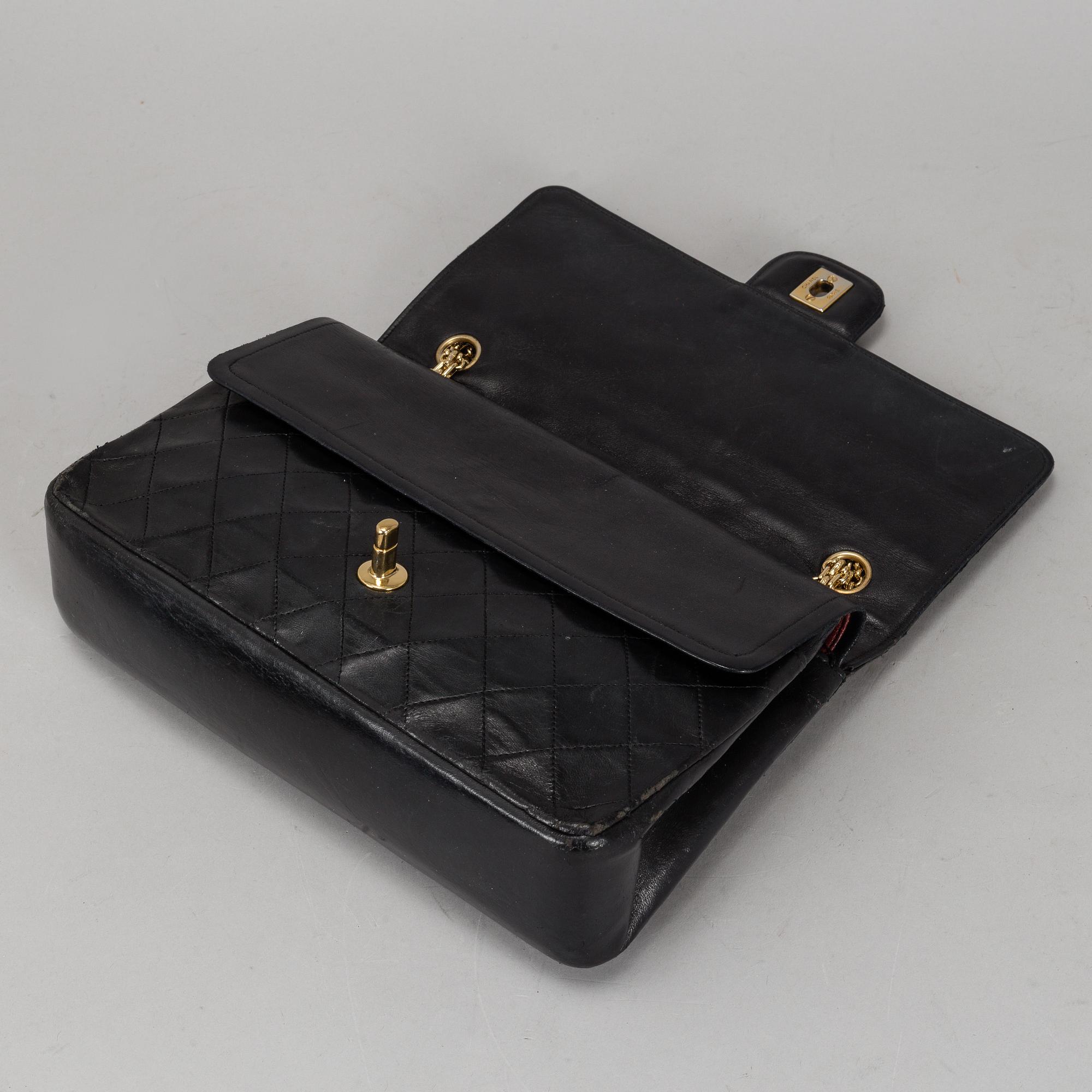 CHANEL, a quilted black leather 'Double Flap Bag'.