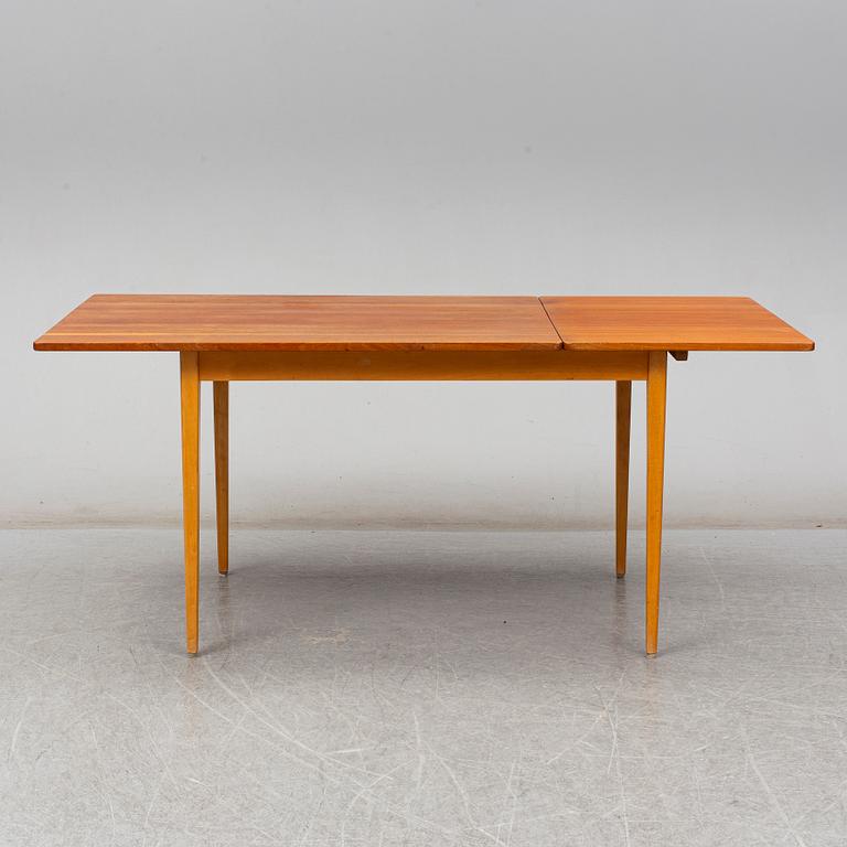 A 1960s teak veneered dining table.