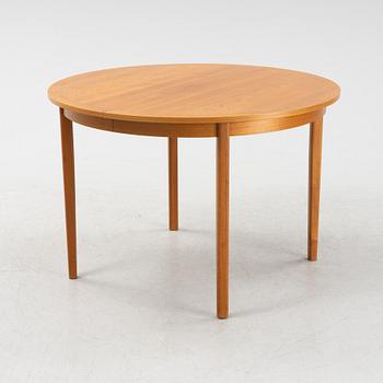 A teak veneer dining table from the mid 20th century.