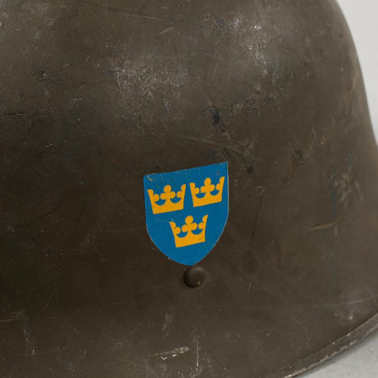 Five military helmets and a hat, late 19th and 20th century.