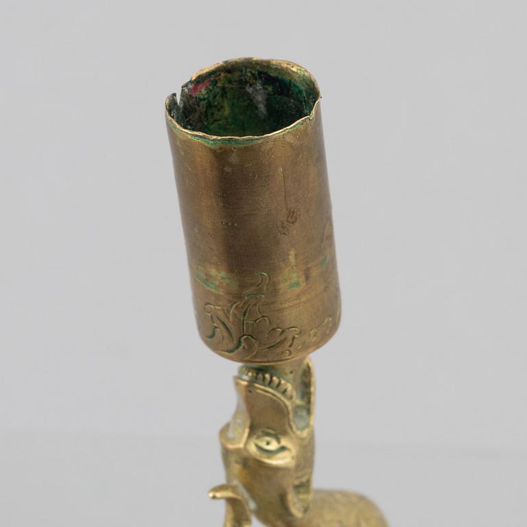 A rococo-style brass candlestick, 18th century and later.