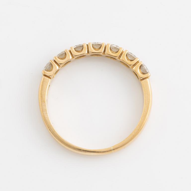 An 18K gold ring set with round brilliant-cut diamonds.