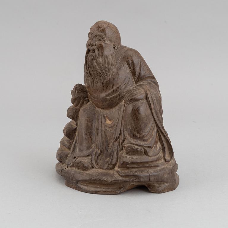 A bambo figure, depicting a seated Zhang Guolao holding a peach, China, 19th/20th century.