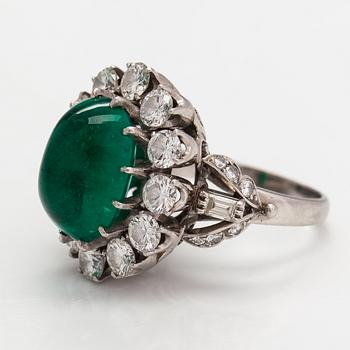 A platinum ring with a ca. 8.50 ct emerald and diamonds ca. 2.84 ct in total. With certificate.