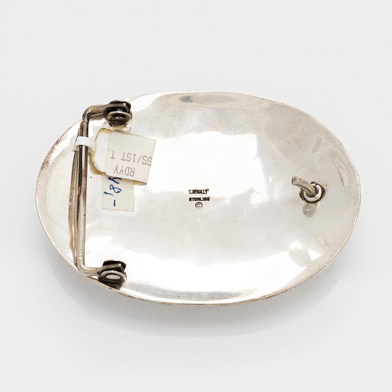 Chester Benally, a silver belt buckle with a turquoise, Navajo.