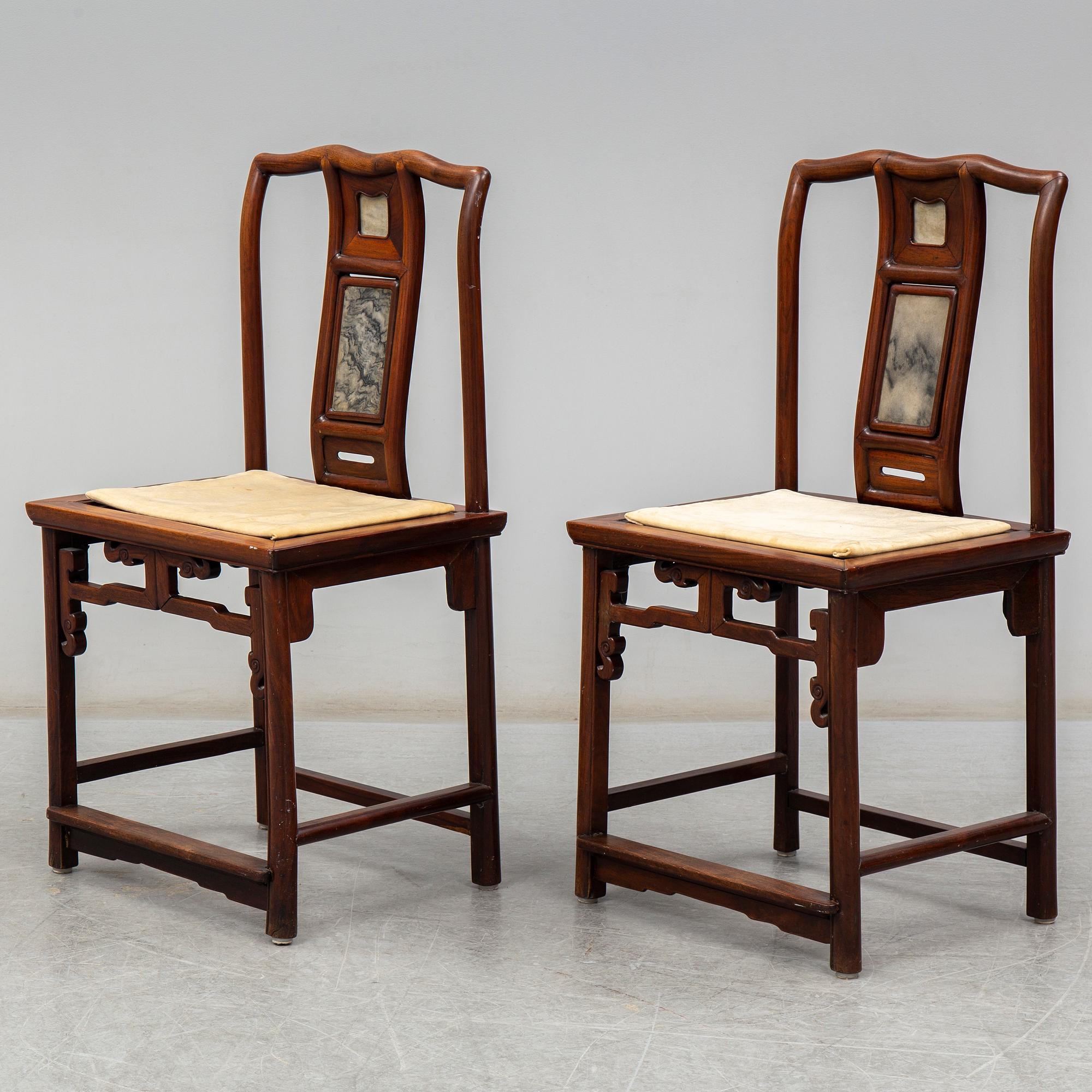 A pair of Chinese hardwood armchairs, early 20th century.