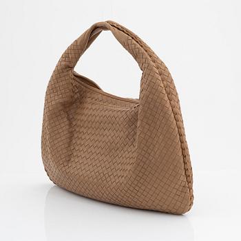 Bottega Veneta, a beige intrecciato leather bag.