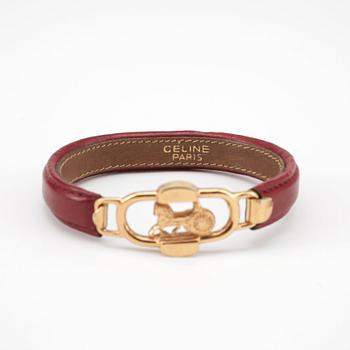 CÉLINE, a winered leather bracelet.