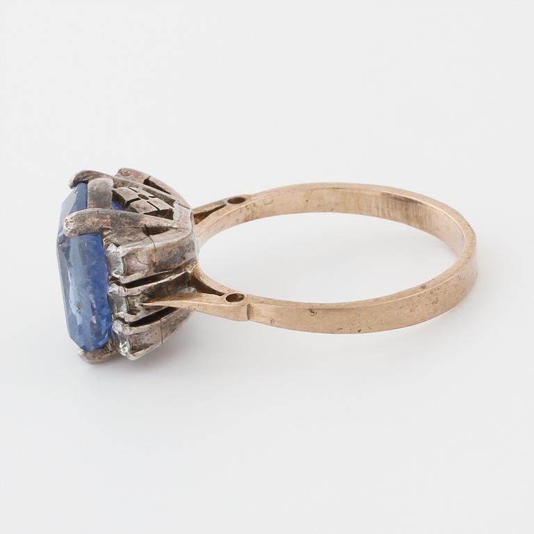 A synthetic sapphire and white gemstone ring.