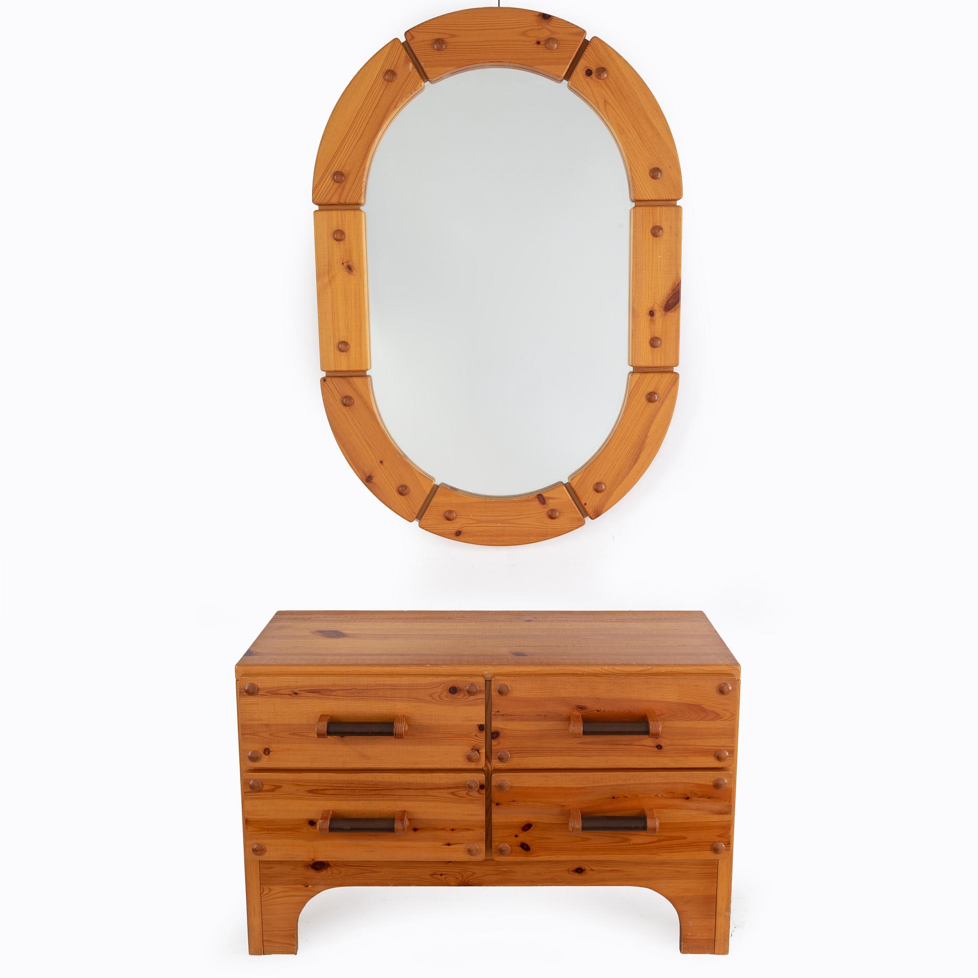 A 1970's set with a pine mirror and chest of drawers.