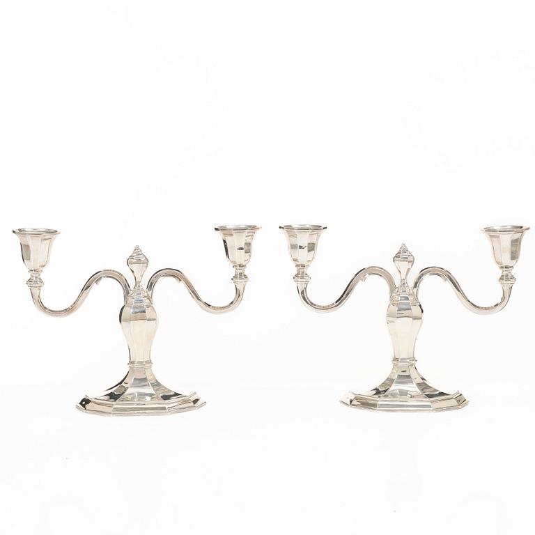 A pair of silver candelabras, with Swedish import marks, possibly mid20th century.