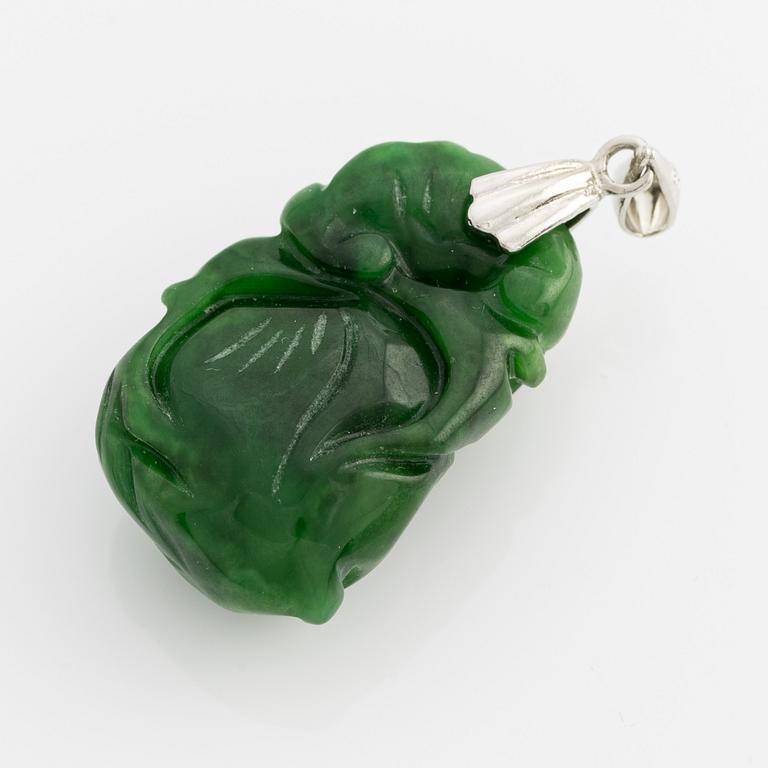 Pendant with carved green stone.