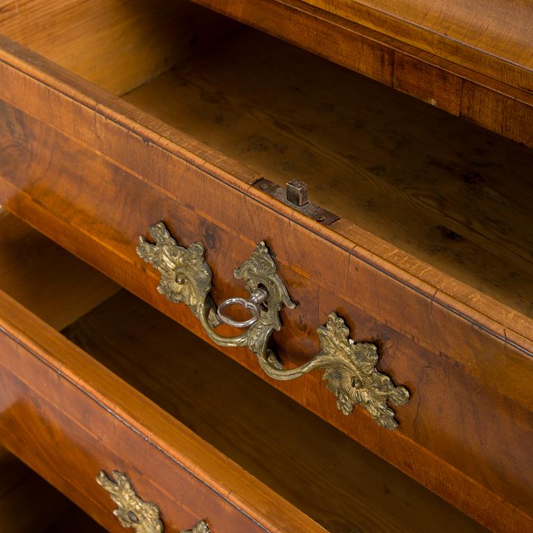 A Swedish walnut-veneered rococo cabinet in the manner of C. Linning, latter half of the 18th Century.