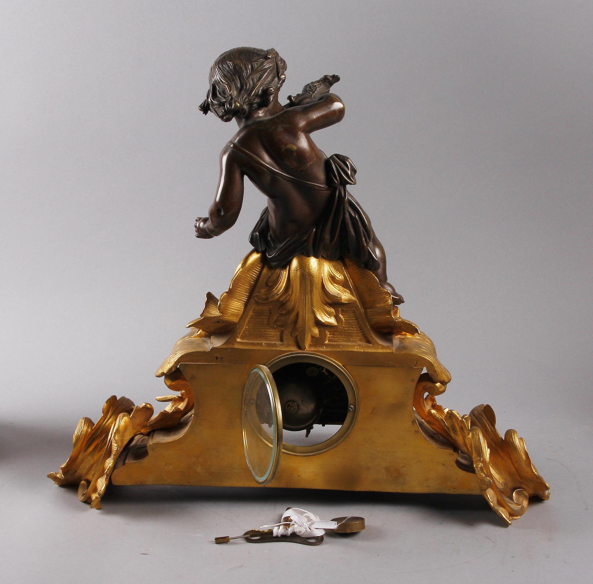 BORDSPENDYL med KANDELABRAR, ett par, Louis XV-stil, 1800-tal.