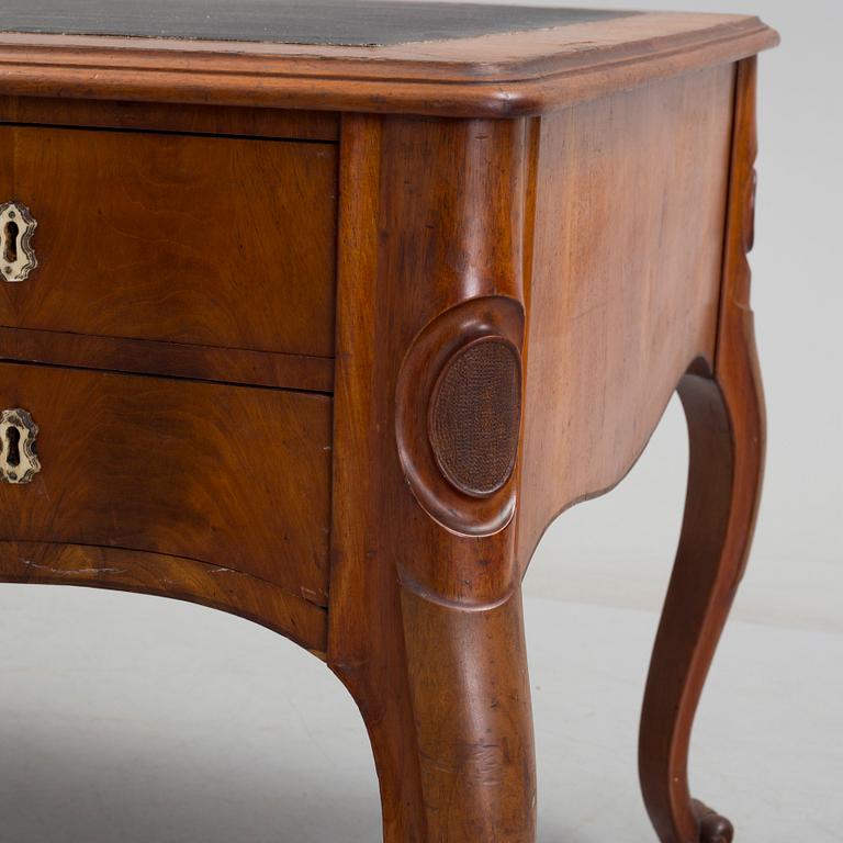 a mahogany rococo-style desk from the second half of the 19th century.