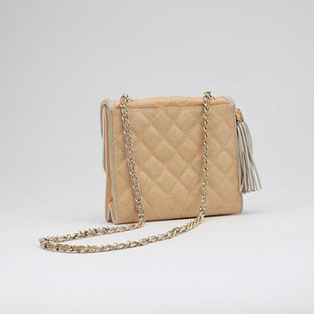 CHANEL, a beige shoulder bag.