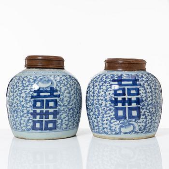 A pair of Chinese blue and white porcealin jars with wooden covers, Qing dynasty, 19th Century.