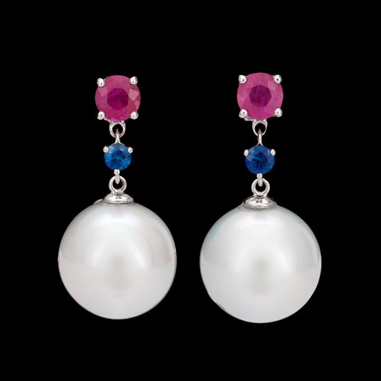 A pair of ruby, sapphire and cultured South sea pearl earrings.