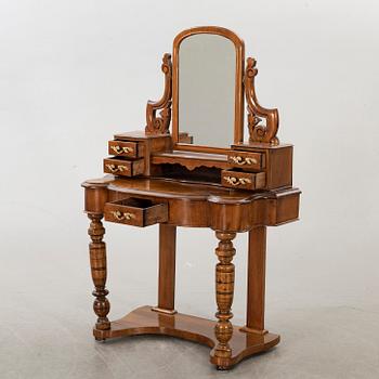 A second half of the 19th century table with mirror and a stool.