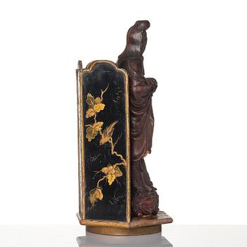 A wooden sculpture of Guanyin with metal inlay, Qing dynasty.