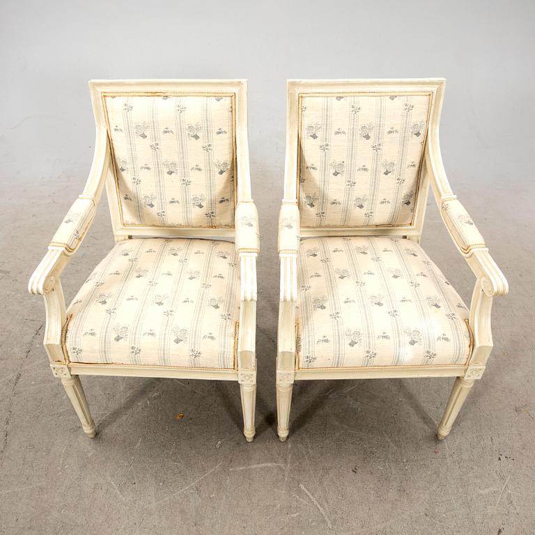 A pair of Gustavian style painted armchairs from around 1900.