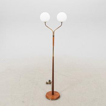 A mid 20th century teak and brass floor lamp.