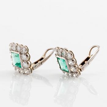 A pair of 14K gold earrings set with step-cut emeralds.