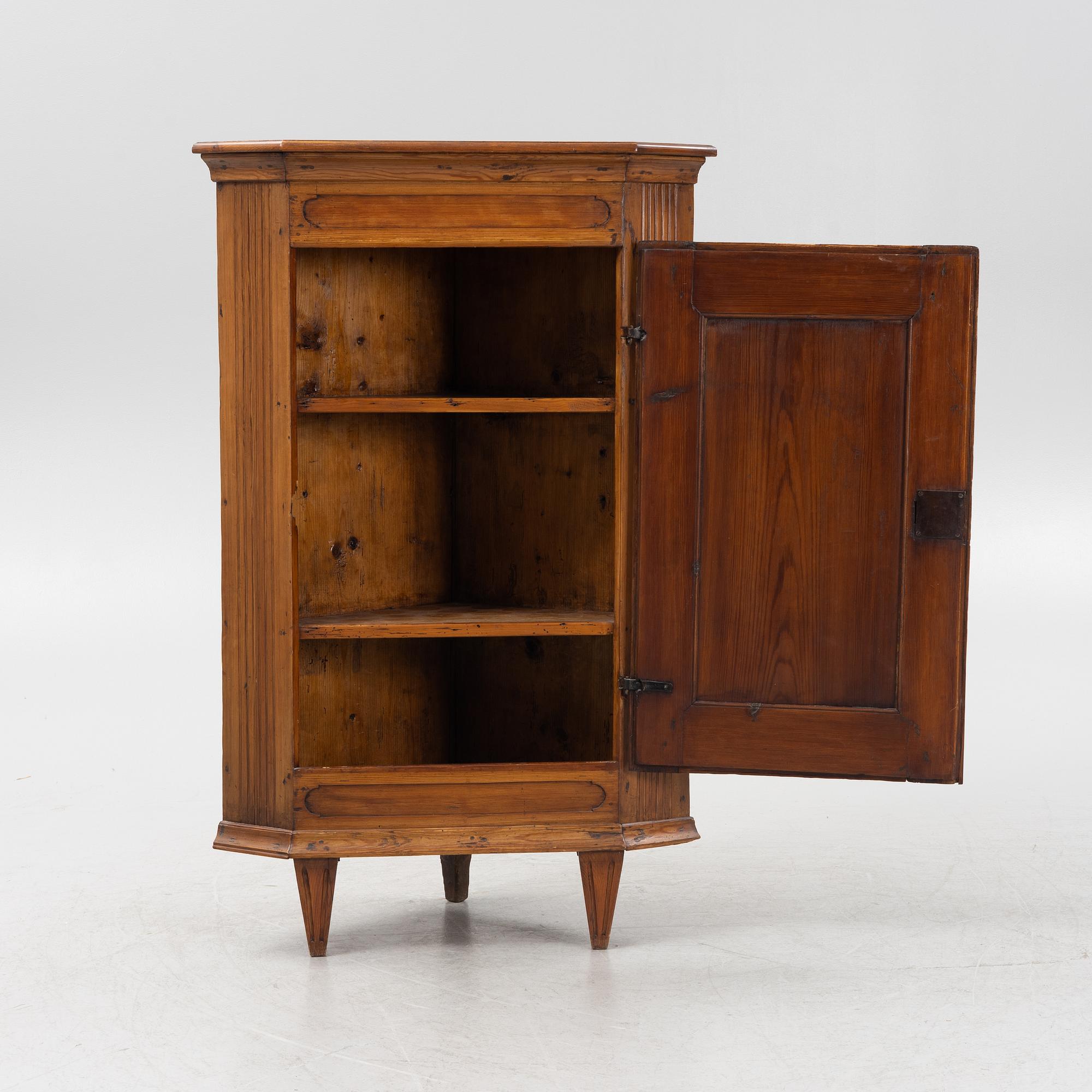 A Gustavian style pinewood corner cupboard, 19th Century.