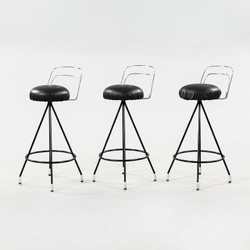 A 1950/60s bar counter with three bar stools.